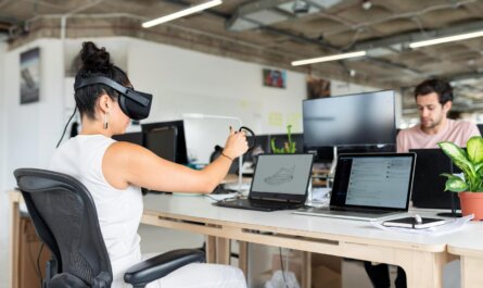 Woman using virtual reality headset in a modern office for design and innovation.