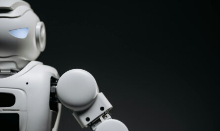 Close-up of a modern, monochrome robot arm against a dark background. Futuristic technology concept.